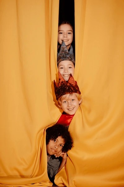 group-children-peeking-yellow-curtain